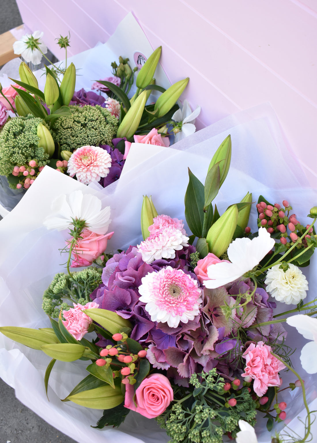 Summer flower bouquets. Purple hydrangea, pink roses with white flowers.
